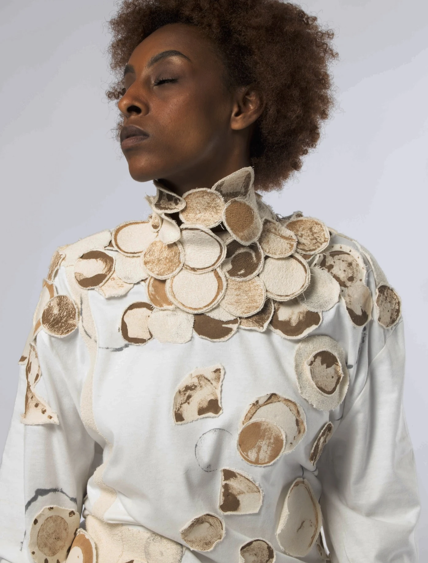 Portrait from Circling Back featuring a sculptural circular garment