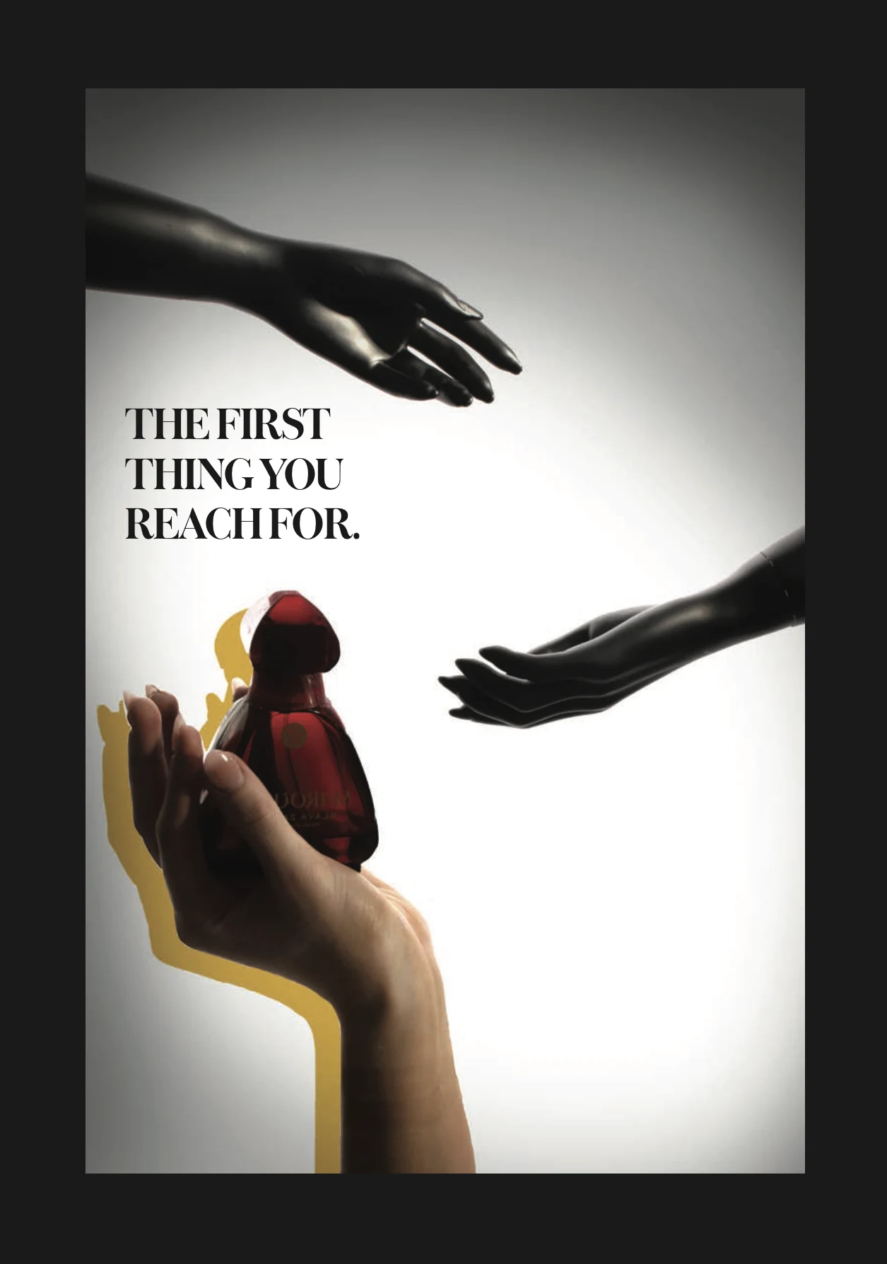 Black-gloved hands framing a small red composition