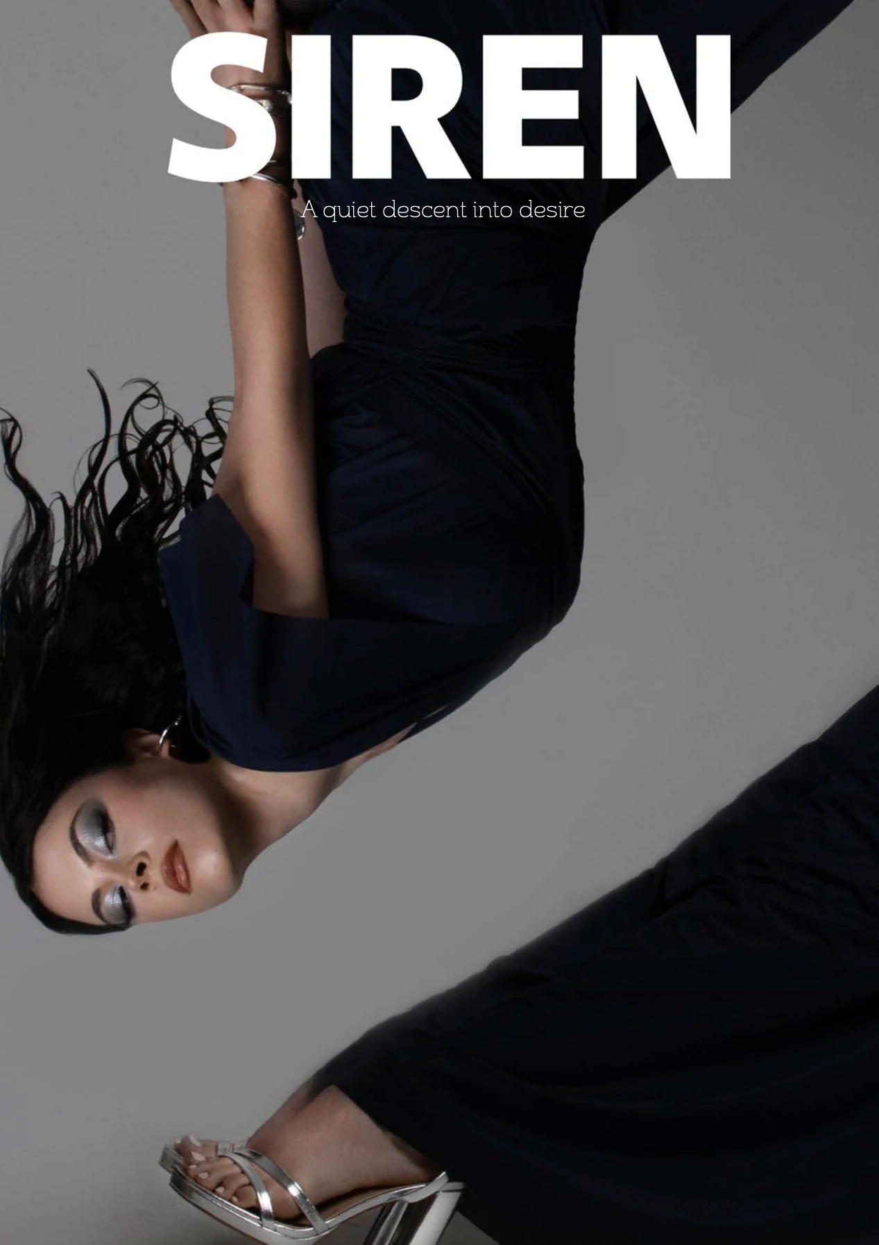 Siren editorial cover with two figures in dark draped looks