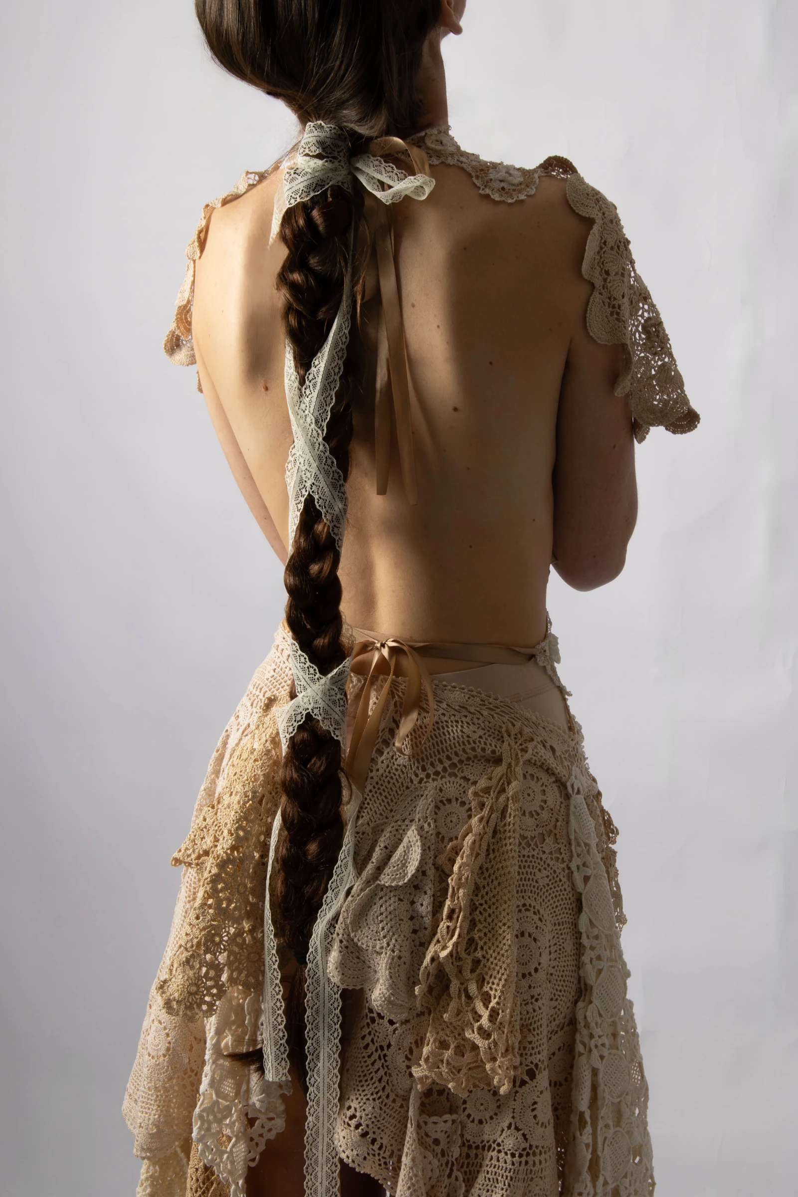 Rear view of a model in a lace garment