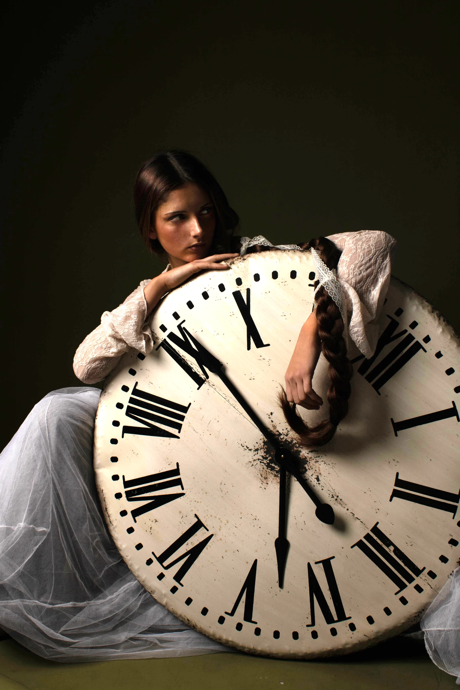 Model reclining against an oversized clock face